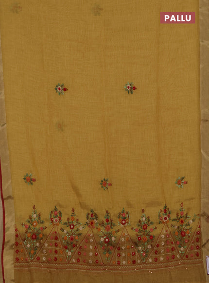 Tissue linen saree mustard green and maroon with embroidery buttas and embroidery pallu