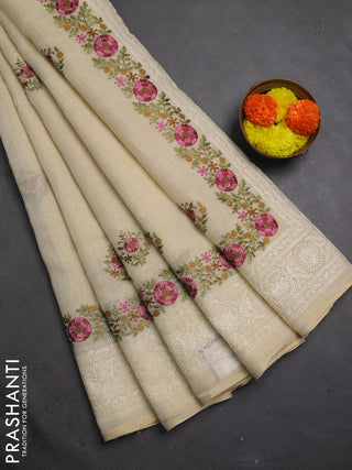 Tissue linen saree cream and pink with embroidery buttas and embroidery border