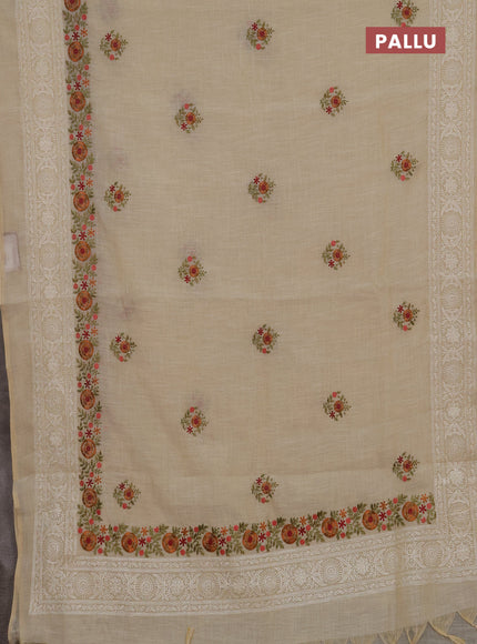 Tissue linen saree cream and rust shade with embroidery buttas and embroidery border