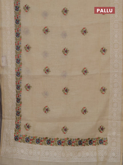 Tissue linen saree cream and grey with embroidery buttas and embroidery border