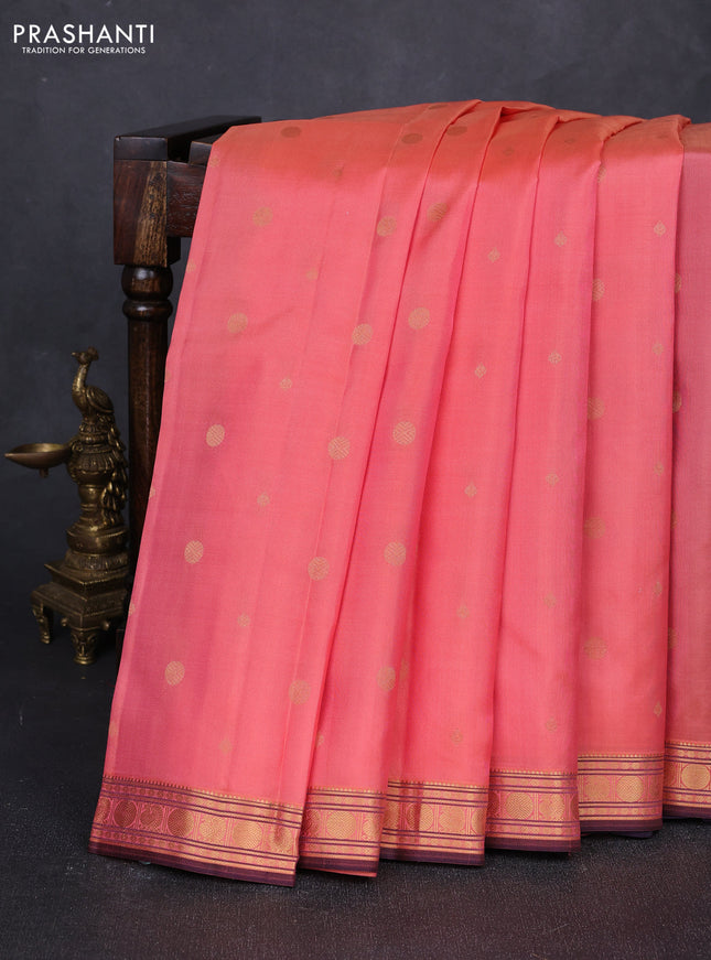 Pure kanchipuram silk saree dual shade of peach and wine shade with allover zari woven geometric buttas and zari woven border