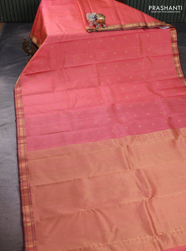Pure kanchipuram silk saree dual shade of peach and wine shade with allover zari woven geometric buttas and zari woven border