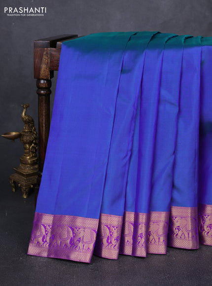 Pure kanchipuram silk saree dual shade of bluish green and purple with plain body and rich zari woven elephnat border