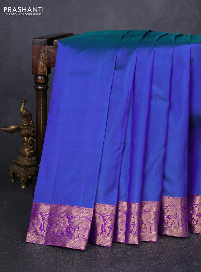 Pure kanchipuram silk saree dual shade of bluish green and purple with plain body and rich zari woven elephnat border