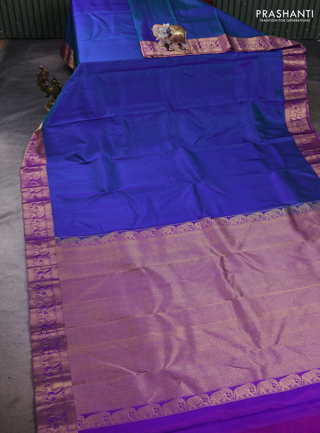 Pure kanchipuram silk saree dual shade of bluish green and purple with plain body and rich zari woven elephnat border