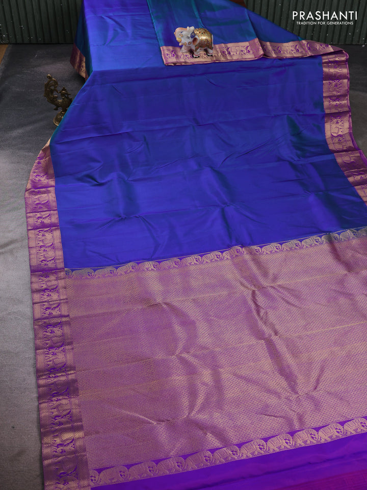 Pure kanchipuram silk saree dual shade of bluish green and purple with plain body and rich zari woven elephnat border
