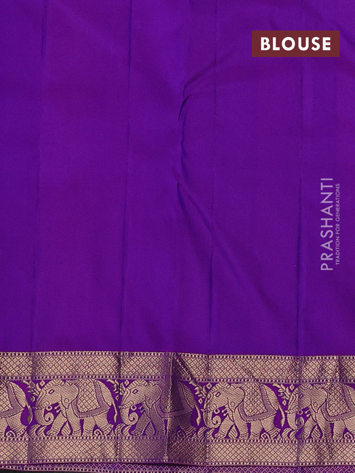 Pure kanchipuram silk saree dual shade of bluish green and purple with plain body and rich zari woven elephnat border