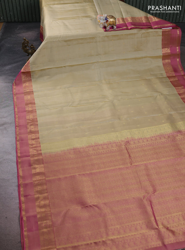 Pure kanchipuram silk saree beige and pink with allover zari woven buttas and rettapet zari woven border