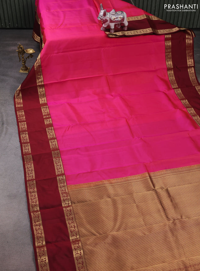 Pure kanchipuram silk saree dual shade of pinkish orange and maroon with plain body and long rettapet zari woven border