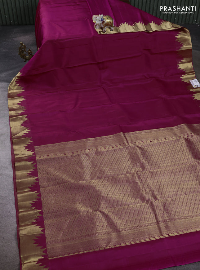 Pure kanchipuram silk saree magenta pink with plain body and temple design zari woven border