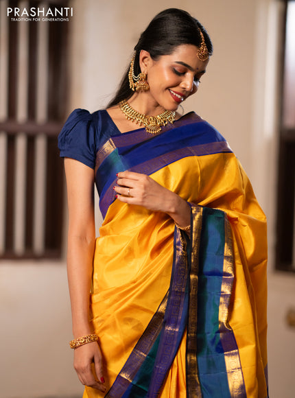 Pure kanchipuram silk saree mango yellow and blue with paisley zari woven buttas and rettapet zari woven border