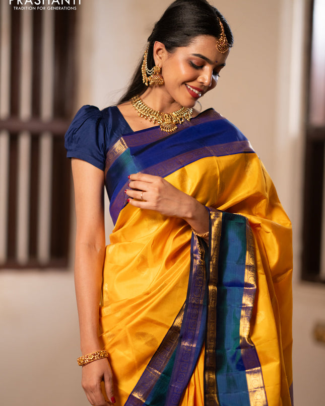 Pure kanchipuram silk saree mango yellow and blue with paisley zari woven buttas and rettapet zari woven border