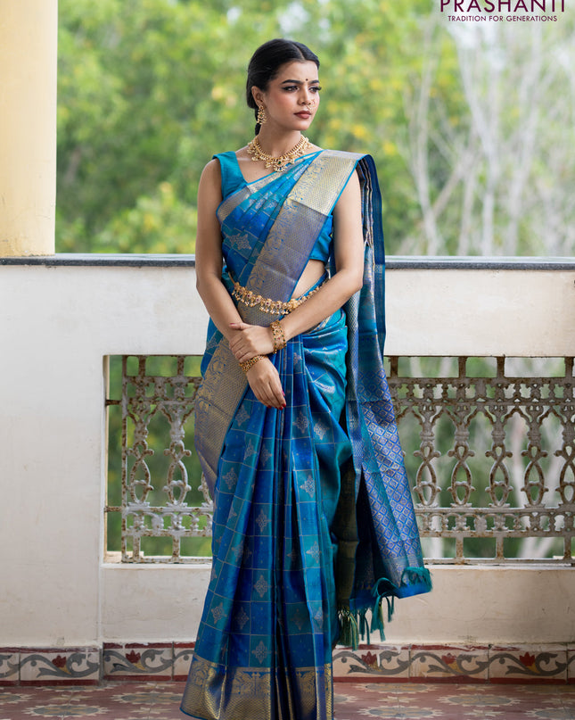 Pure kanchipuram silk saree dual shade of peacock blue with allover self emboss & zari weaves and zari woven border