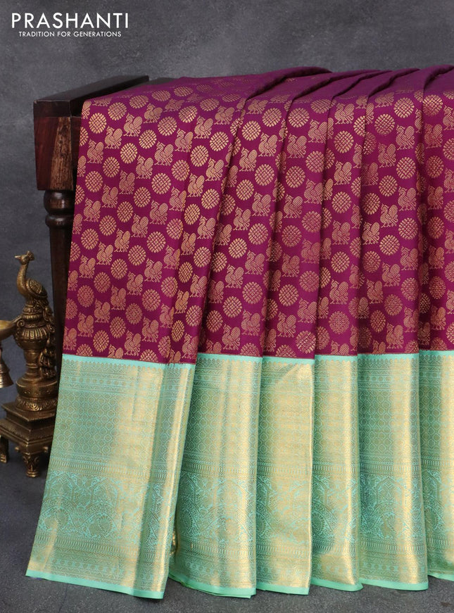 Pure kanjivaram silk saree deep purple and teal blue shade with allover annam zari woven butta weaves and rich zari woven border