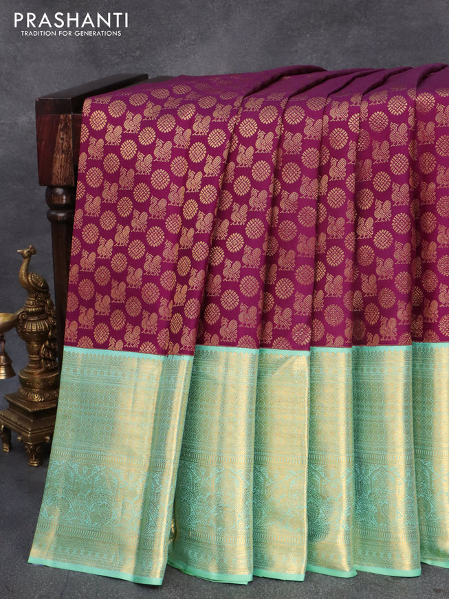 Pure kanjivaram silk saree deep purple and teal blue shade with allover annam zari woven butta weaves and rich zari woven border