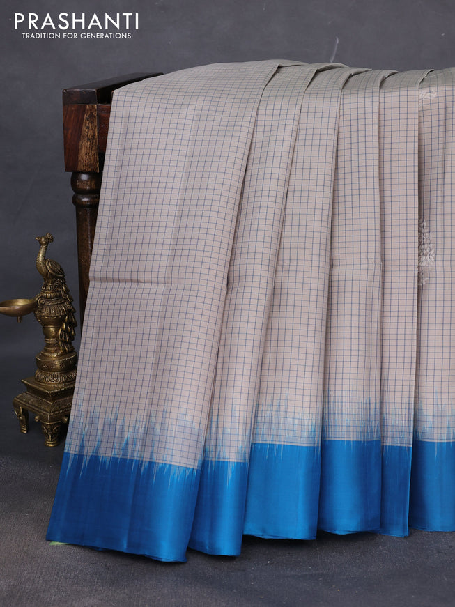 Pure soft silk saree grey shade and peacock blue with allover checked pattern & zari woven buttas and simple border