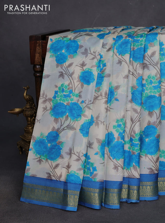 Printed silk saree cream and blue with allover floral prints and zari woven border