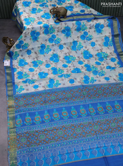 Printed silk saree cream and blue with allover floral prints and zari woven border