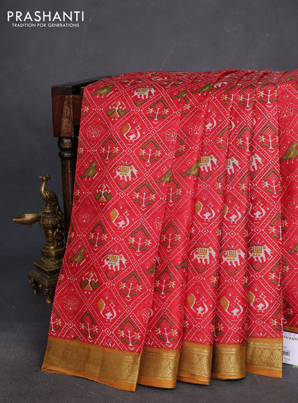 Printed silk saree red and dark mustard with allover ikat prints and zari woven border
