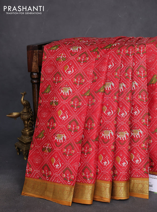 Printed silk saree red and dark mustard with allover ikat prints and zari woven border