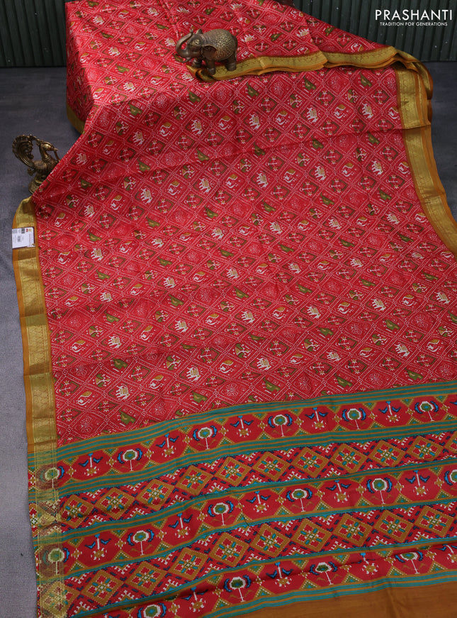 Printed silk saree red and dark mustard with allover ikat prints and zari woven border