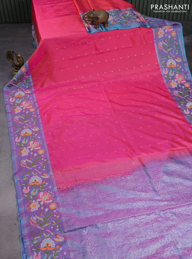 Pure soft silk saree dual shade of pinkish orange and blue shade with silver zari woven buttas and floral design embroidery border