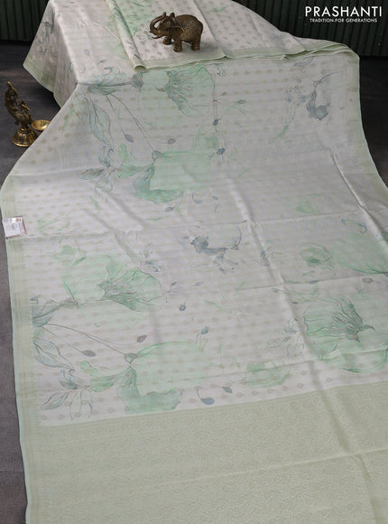 Chiniya silk saree off white and pastel green with allover silver zari buttas & digital prints and zari woven border