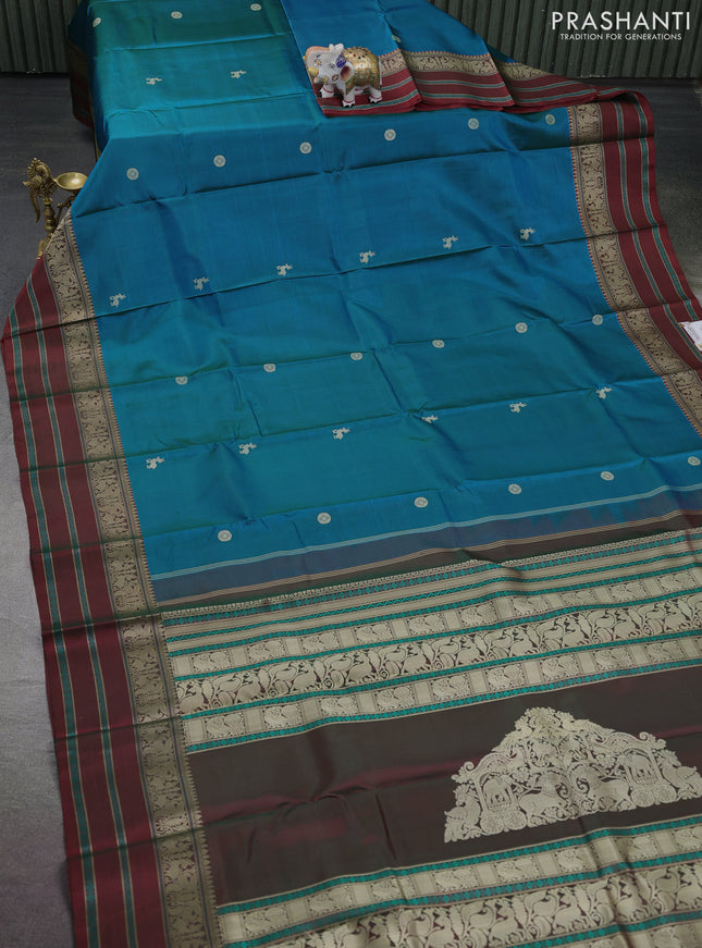 Pure kanchipuram silk saree dual shade of bluish green and maroon with thread woven buttas and thread woven border