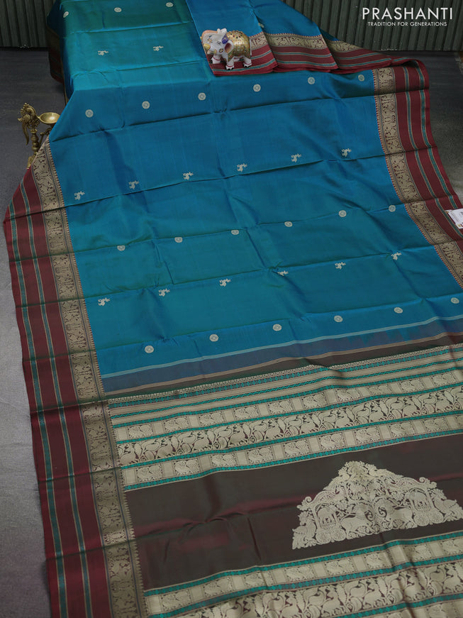 Pure kanchipuram silk saree dual shade of bluish green and maroon with thread woven buttas and thread woven border
