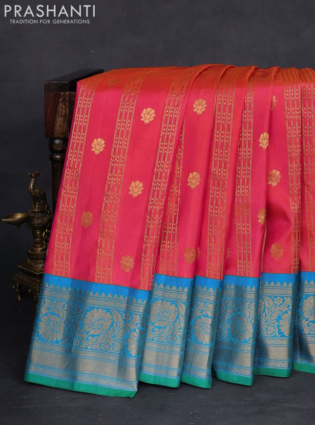 Pure gadwal silk saree dual shade of pinkish orange and dual shade of teal blue with allover zari weaves & buttas and floral zari woven border