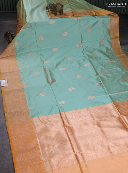 Banarasi katan silk saree pastel green and pale orange with copper zari woven buttas and zari woven border