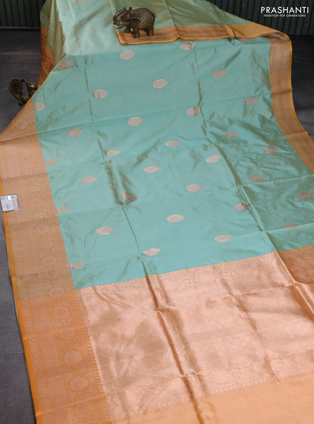 Banarasi katan silk saree pastel green and pale orange with copper zari woven buttas and zari woven border