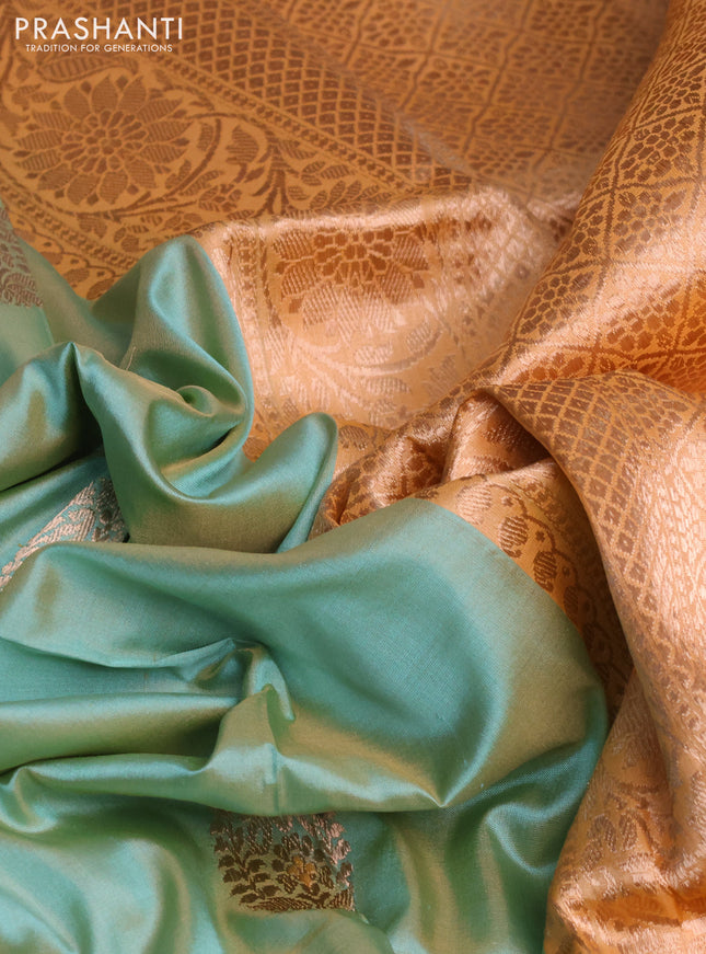 Banarasi katan silk saree pastel green and pale orange with copper zari woven buttas and zari woven border