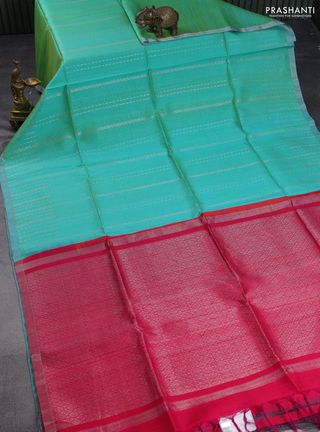 Pure raw silk saree dual shade of teal and reddish pink with allover silver zari weaves and small zari woven border