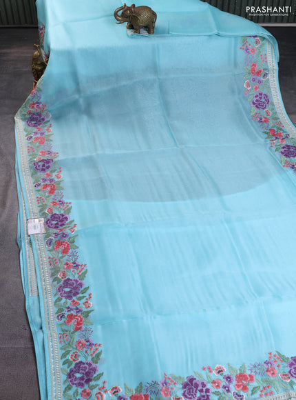 Pure organza silk saree light blue with plain body and floral embroidery border