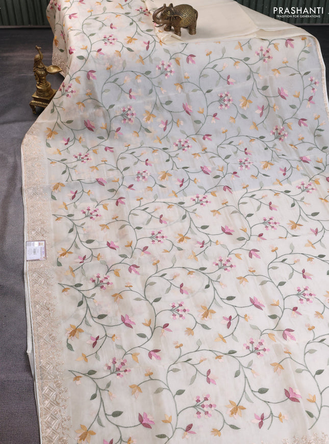 Pure organza silk saree cream with allover embroidery and embroidery border