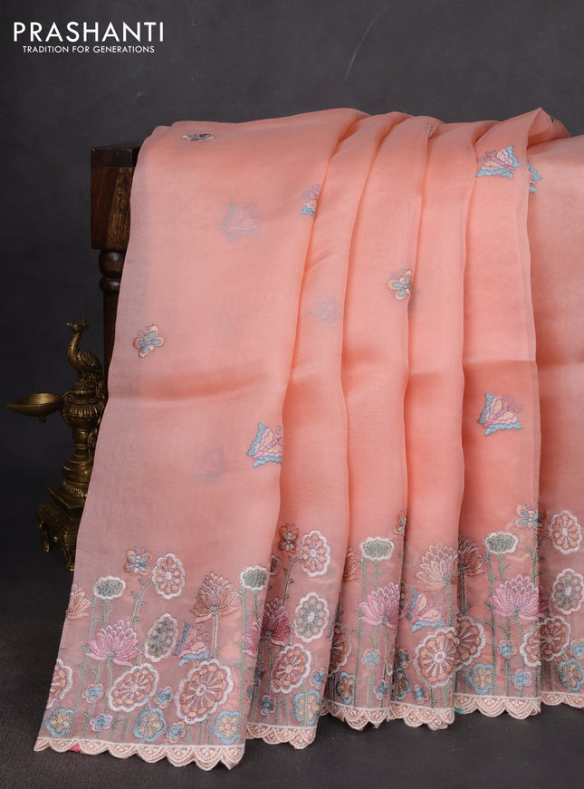 Pure organza silk saree peach shade with butterfly embroidery buttas and embroidery border
