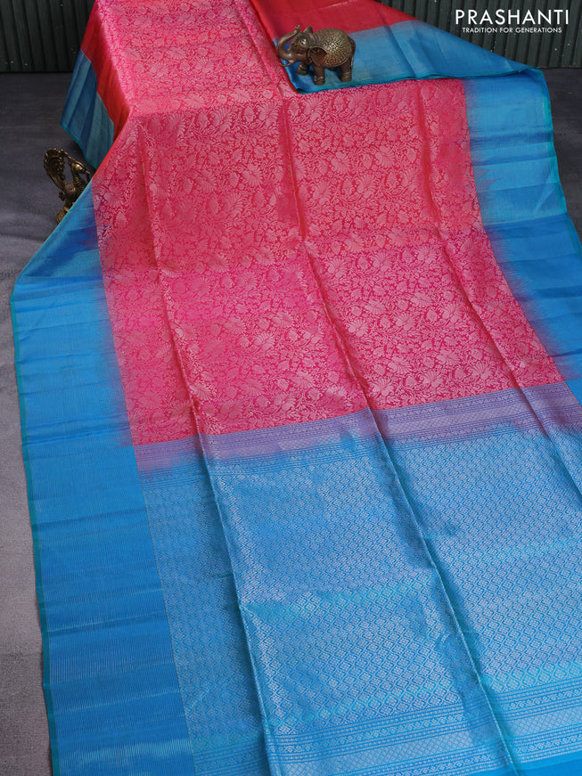 Pure soft silk saree dual shade of pinkish orange and teal blue with allover silver zari woven brocade weaves and zari woven border