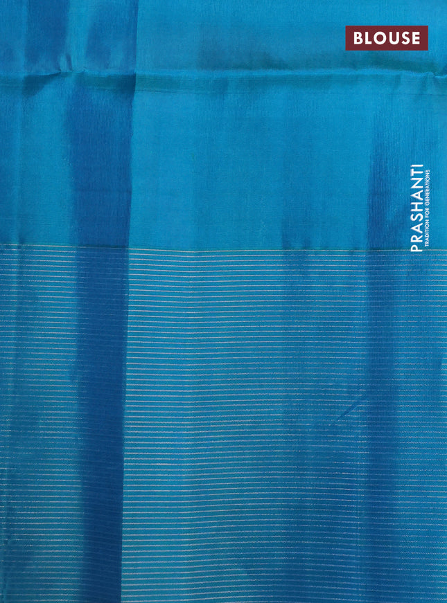 Pure soft silk saree dual shade of pinkish orange and teal blue with allover silver zari woven brocade weaves and zari woven border