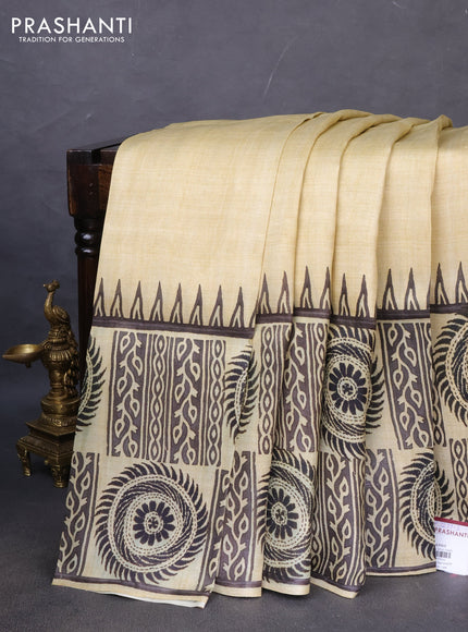 Printed silk saree beige and black with plain body and long printed border