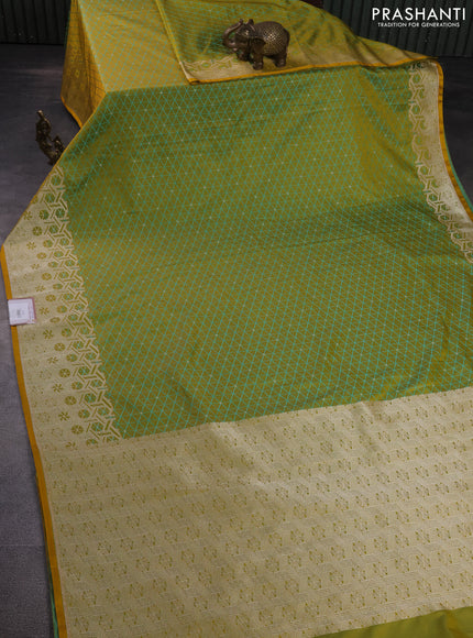 Banarasi semi mushru silk saree dual shade of mustard yellow and teal blue with allover self emboss & zari buttas and zari woven border