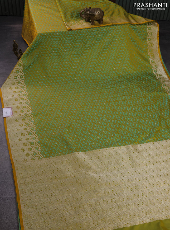 Banarasi semi mushru silk saree dual shade of mustard yellow and teal blue with allover self emboss & zari buttas and zari woven border