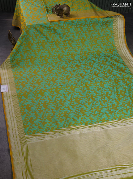 Banarasi semi mushru silk saree dual shade of mustard and teal green shade with allover self emboss and zari woven border
