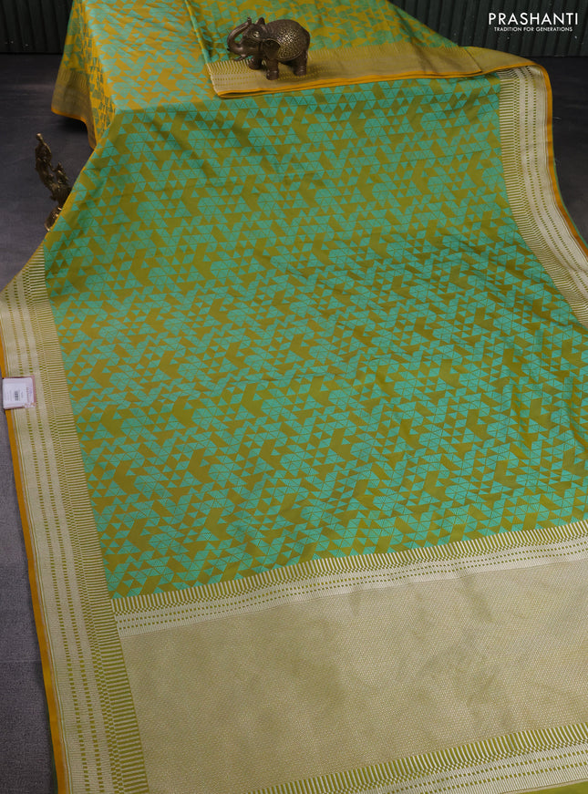 Banarasi semi mushru silk saree dual shade of mustard and teal green shade with allover self emboss and zari woven border