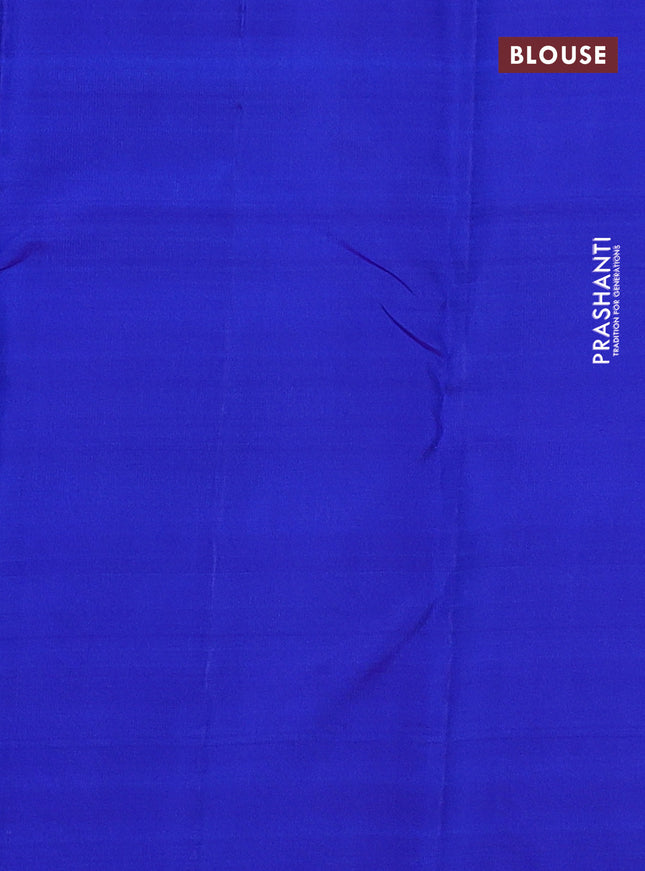 Pure kanchipuram silk saree dual shade of pinkish orange and blue with zari woven buttas and temple design zari woven border