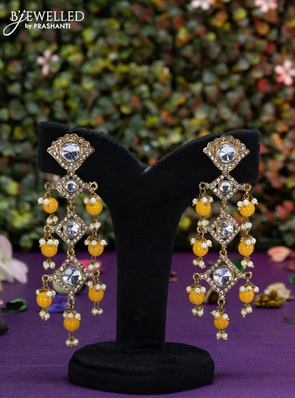 Fashion dangler earrings with kundan stones and yellow beads hangings