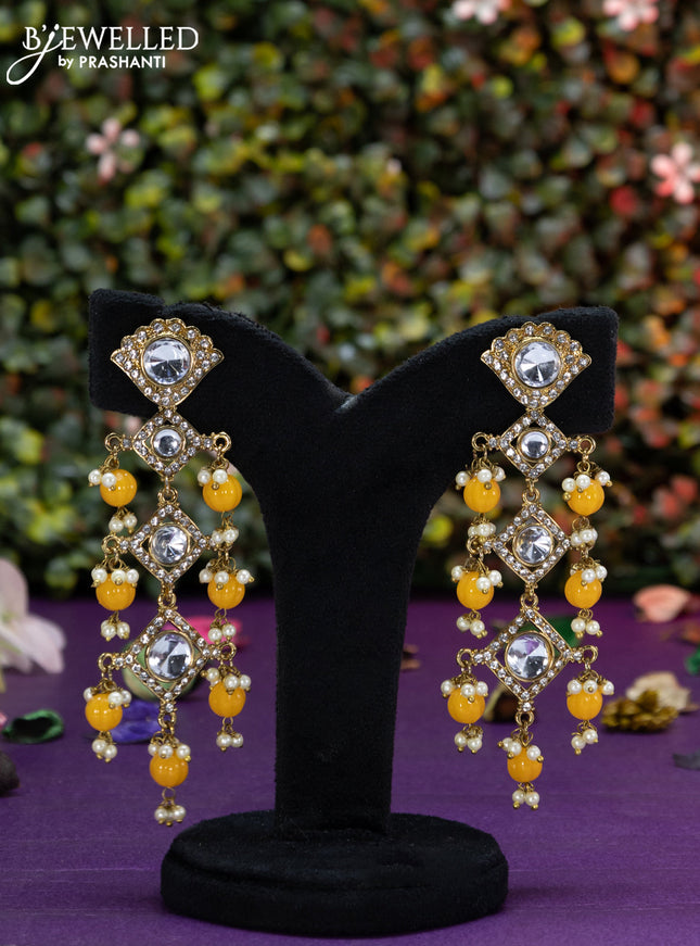 Fashion dangler earrings with kundan stones and yellow beads hangings