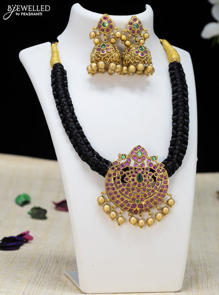 Black thread necklace with kemp stone and golden beads hanging