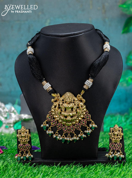 Black thread necklace with kemp stone lakshmi pendant and green beads hangings