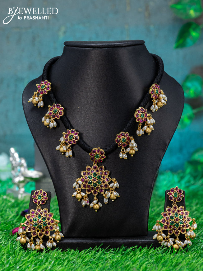 Black thread necklace with floral design & kemp stone and beads hanging